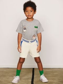 Grey melange organic cotton T-shirt featuring embroidered Minibabies and tennis patches, worn by a child.