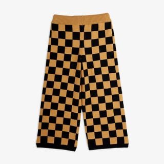 Brown and black chess check knitted trousers featuring a ribbed waistband, shown from the back.