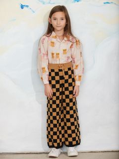 Brown and black chess check knitted trousers featuring a drawstring waist.