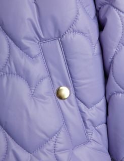 Close-up of a purple heart-quilted puffer jacket featuring a gold snap button and stitching.