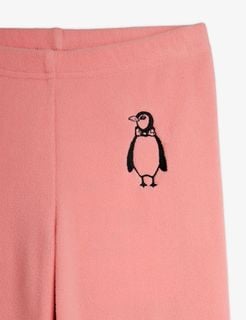 Close-up of pink microfleece trousers featuring a detailed penguin embroidery with a bow tie.