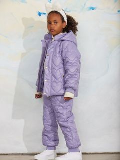 Purple quilted outerwear trousers and matching jacket with a heart pattern worn by a child.