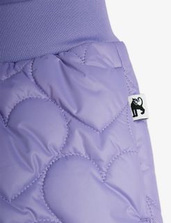Close-up of purple quilted trousers featuring a heart pattern, ribbed waistband, and a black panther logo tag.