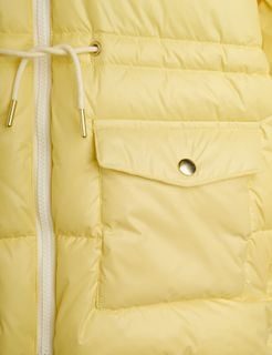 Yellow puffer jacket detail showing a white zipper, pocket with a gold snap button, and white drawstring.