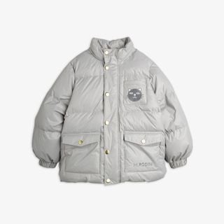 Grey heavy puffer jacket featuring gold-toned snap buttons, front flap pockets, and a cat face patch on the chest.