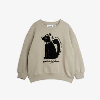 Light grey sweatshirt featuring a black and white skunk chenille artwork and ribbed trims.