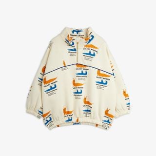 Off-white half-zip sweatshirt featuring a colorful Velvet worms print, high collar, and elasticated hem.