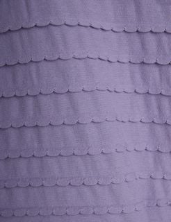 Close-up of purple fabric featuring horizontal rows of textured scalloped frills.