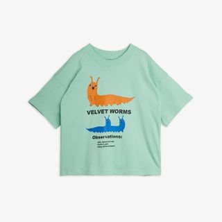 Green T-shirt featuring a Velvet worm print with text, dropped shoulders, and a ribbed neckline.