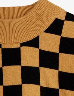 Close-up of a brown knitted sweater with a black Chess check pattern and ribbed neckline.