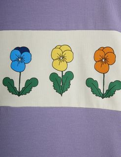 Close-up of a panel featuring blue, yellow, and orange flowers on a purple top.