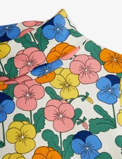 Close-up of the Violas floral print featuring pink, blue, yellow, and orange flowers on a white turtleneck.