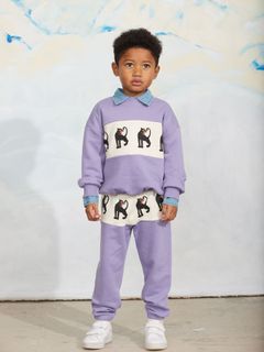Purple sweatpants with a white Panther print panel, worn by a child with a matching sweatshirt.