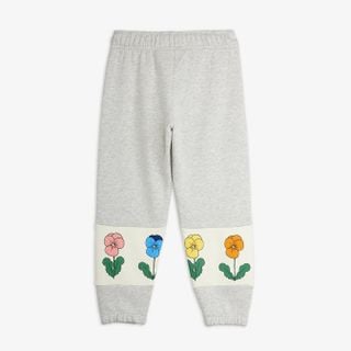 Grey melange sweatpants with colorful Violas print on cream leg panels, shown from the back.