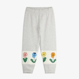 Grey melange sweatpants featuring cream leg panels with a colorful Violas flower print.