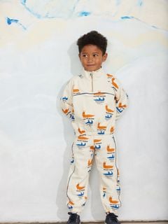 Off-white organic cotton sweatpants and matching sweatshirt featuring a Velvet worms print and blue side piping.