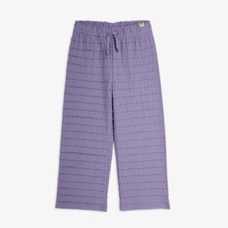 Purple trousers featuring textured horizontal frills, scalloped edges, and an elastic drawstring waist.