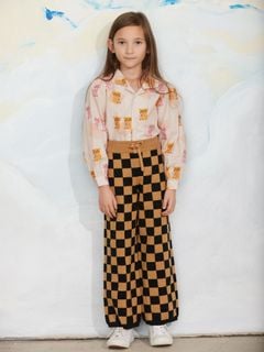Beige blouse with a Kittens print, camp collar, and puff sleeves, paired with black and brown checkered pants.