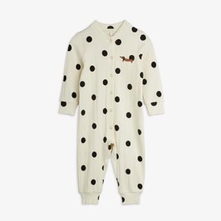 Off-white jumpsuit featuring a black dots print, snap buttons down the front, and a dachshund dog patch on the chest.