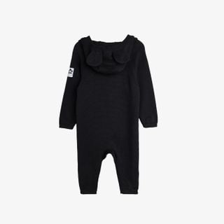Black fine knit baby jumpsuit with a mouse-ear hood and panda label, seen from the back.