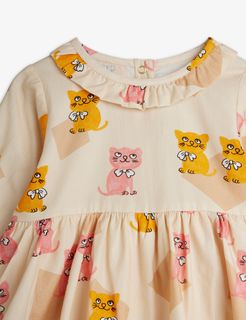 Close-up of a cream bodysuit featuring a yellow and pink Kittens print and a ruffled collar.