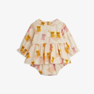 Beige bodysuit featuring a Kittens print, ruffled collar, skirted waist, long sleeves, and back snap buttons, shown from the back.