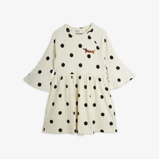 Off-white dress featuring black polka dots, flared trumpet sleeves, and a small dog embroidery on the chest.