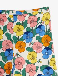 Close-up of trousers featuring a colorful Violas print with pink, yellow, blue, and orange flowers.