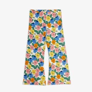 Flared trousers featuring an all-over colorful viola flower print on a light background.