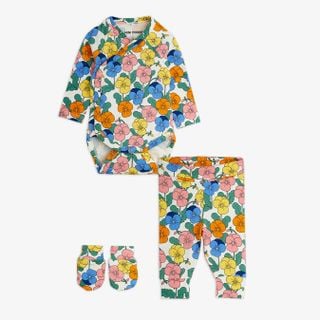 Three-piece newborn kit in a colorful Violas print, including a wrap bodysuit, trousers, and mittens.