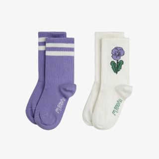 Purple socks with white stripes and off-white socks with a purple Viola flower print and ribbed shafts.