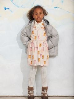Pink dress featuring a Kittens print, pointed collar, and button front, styled with a grey puffer jacket.