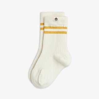 Off-white ribbed socks featuring yellow stripes and a signature panda label.