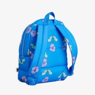 Blue padded backpack featuring a purple Violas floral print and adjustable shoulder straps, shown from the back.