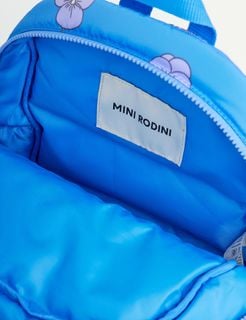 Close-up of the blue padded backpack interior featuring the Mini Rodini brand label.