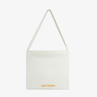 Off-white tote bag featuring long handles and an orange Mini Rodini logo print at the bottom.