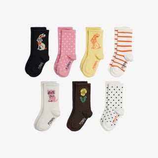 Multi-colored 7-pack of ribbed socks with rabbit, cat, and flower motifs, stripes, and polka dots.