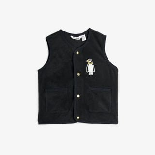 Black microfleece vest featuring a penguin patch, gold snap buttons and two front pockets.