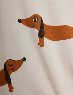Close-up of grey dress fabric featuring a print of brown dachshund dogs.
