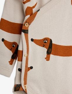 Close-up of a grey wrap bodysuit featuring the brown Dog print and snap button closures.