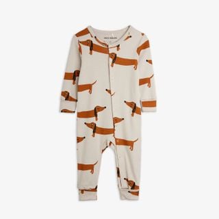 Grey organic cotton jumpsuit featuring an iconic dog print and snap buttons.