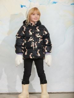 Black hooded puffer jacket featuring a rabbit pattern, worn by a child.