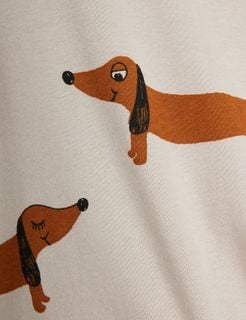 Close-up of a grey swaddle blanket featuring a brown dachshund Dog print.