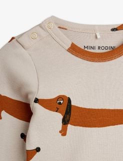 Grey organic cotton bodysuit with a brown Dog print, featuring gold snap buttons at the shoulder.