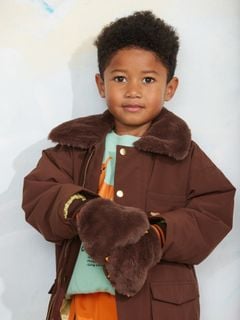 Brown padded nylon parka with a soft faux fur collar, worn by a child.