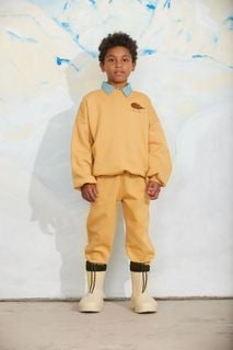 Beige sweatshirt featuring an embroidered elephant shrew and matching trousers on a child model.