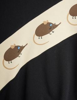 Close-up of the Elephant shrew print on an off-white panel against black sweatshirt fabric.