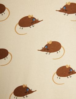Close-up of beige fabric featuring a repeating brown Elephant shrew print with blue eyes.