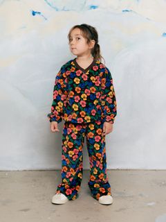 Velour sweatshirt and matching trousers with a colorful Viola print, worn by a child.