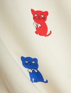 Kittens print detail on off-white sweatshirt showing red and blue cats with white bows.